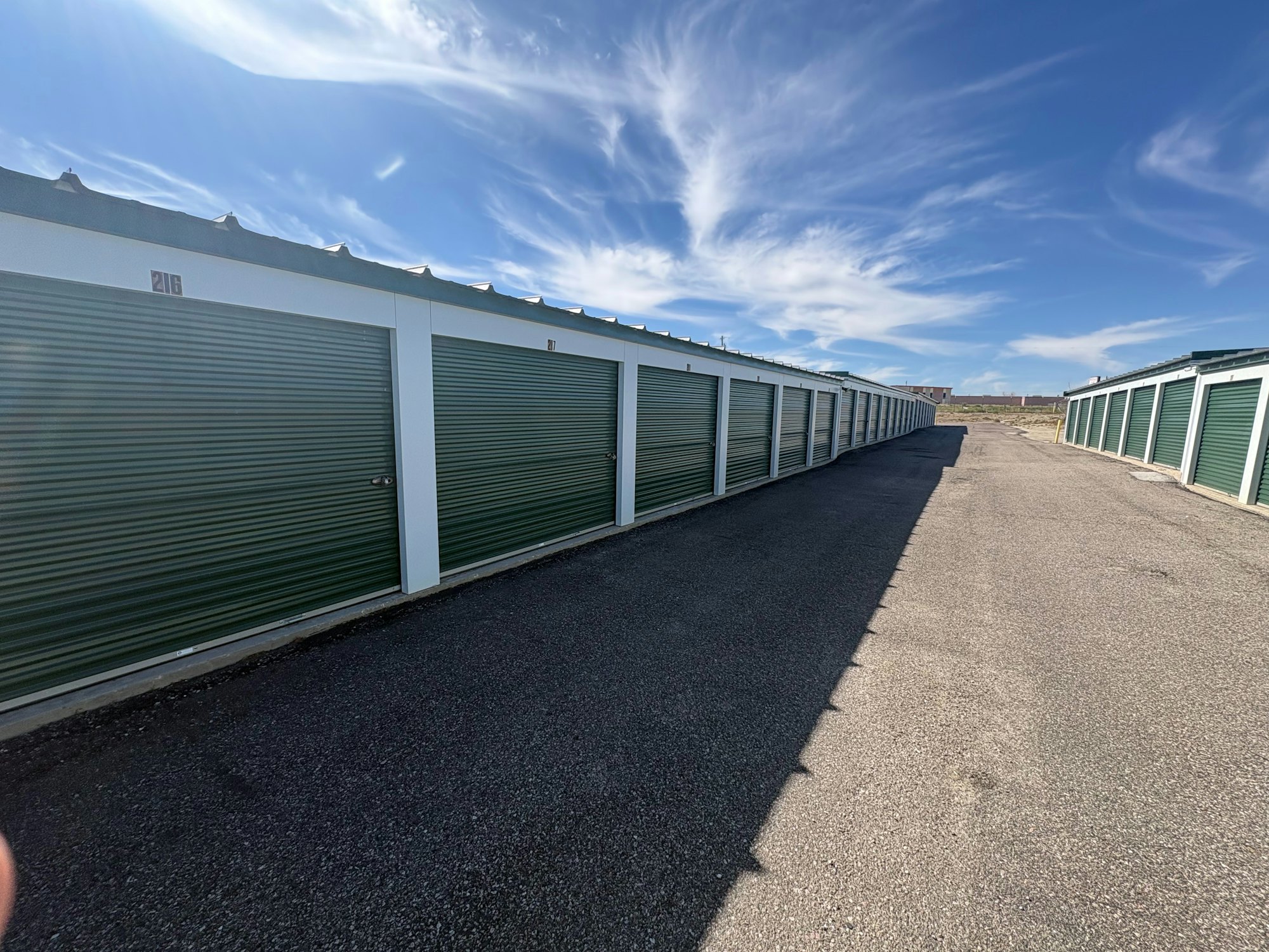 Rows of storage units under a bright sky